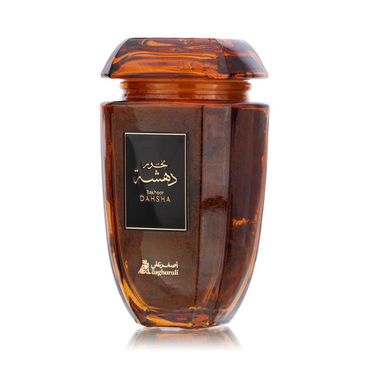 Angled view of Dahsha Bakhoor 180Grm jar, showcasing its rich amber hue and label