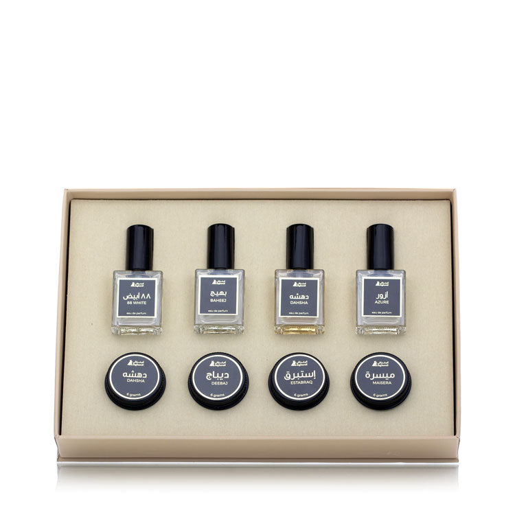 Set of four perfume bottles with labels in a beige box on a white background